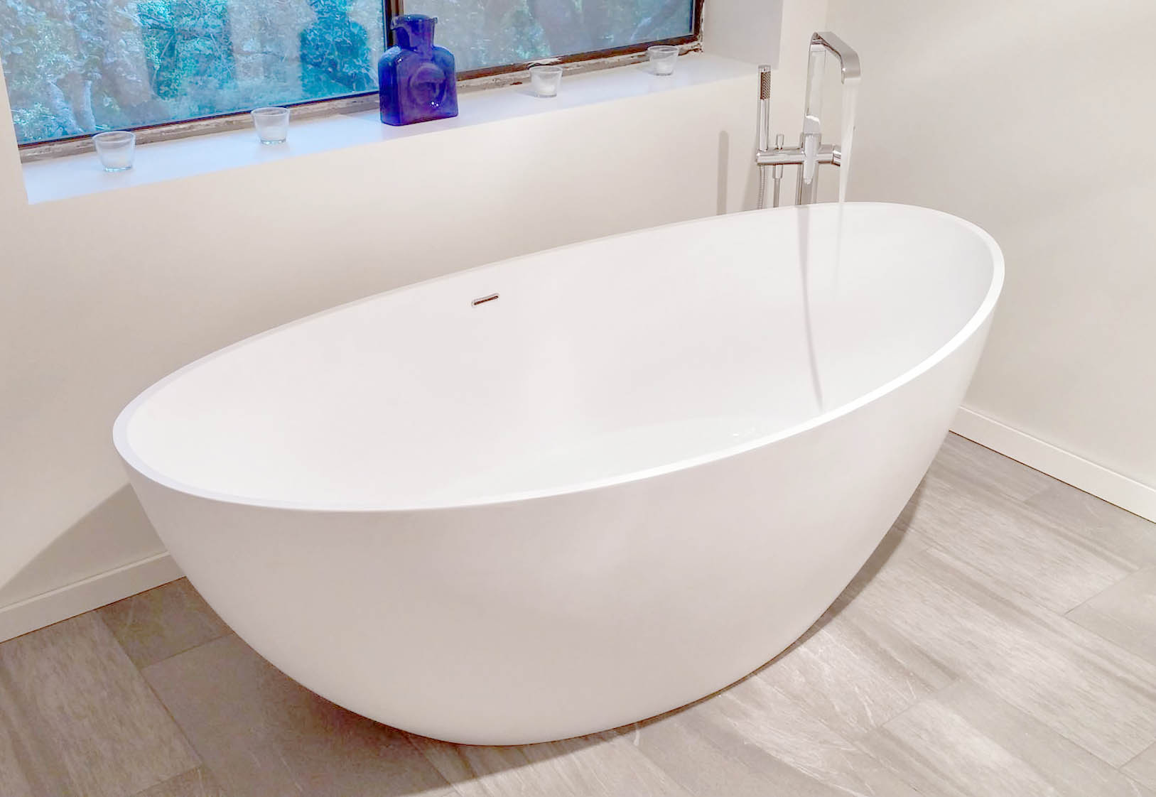 luxury bathtub with freestanding faucet and showerhead