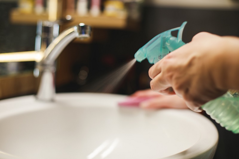 Woman cleaning bathroom