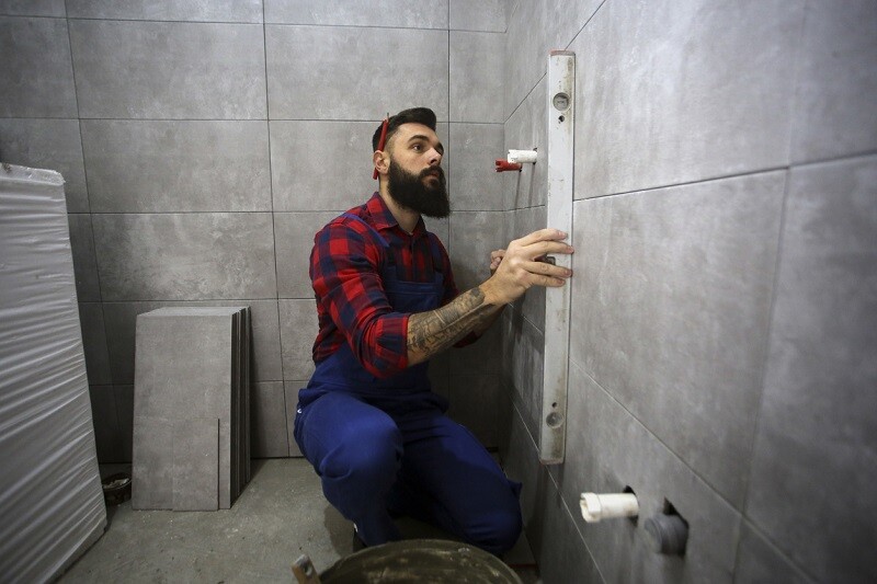 professional taking measurement of bathroom.